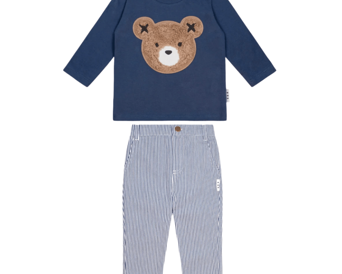 Navy blue long-sleeve shirt with bear design and striped pants on a white background